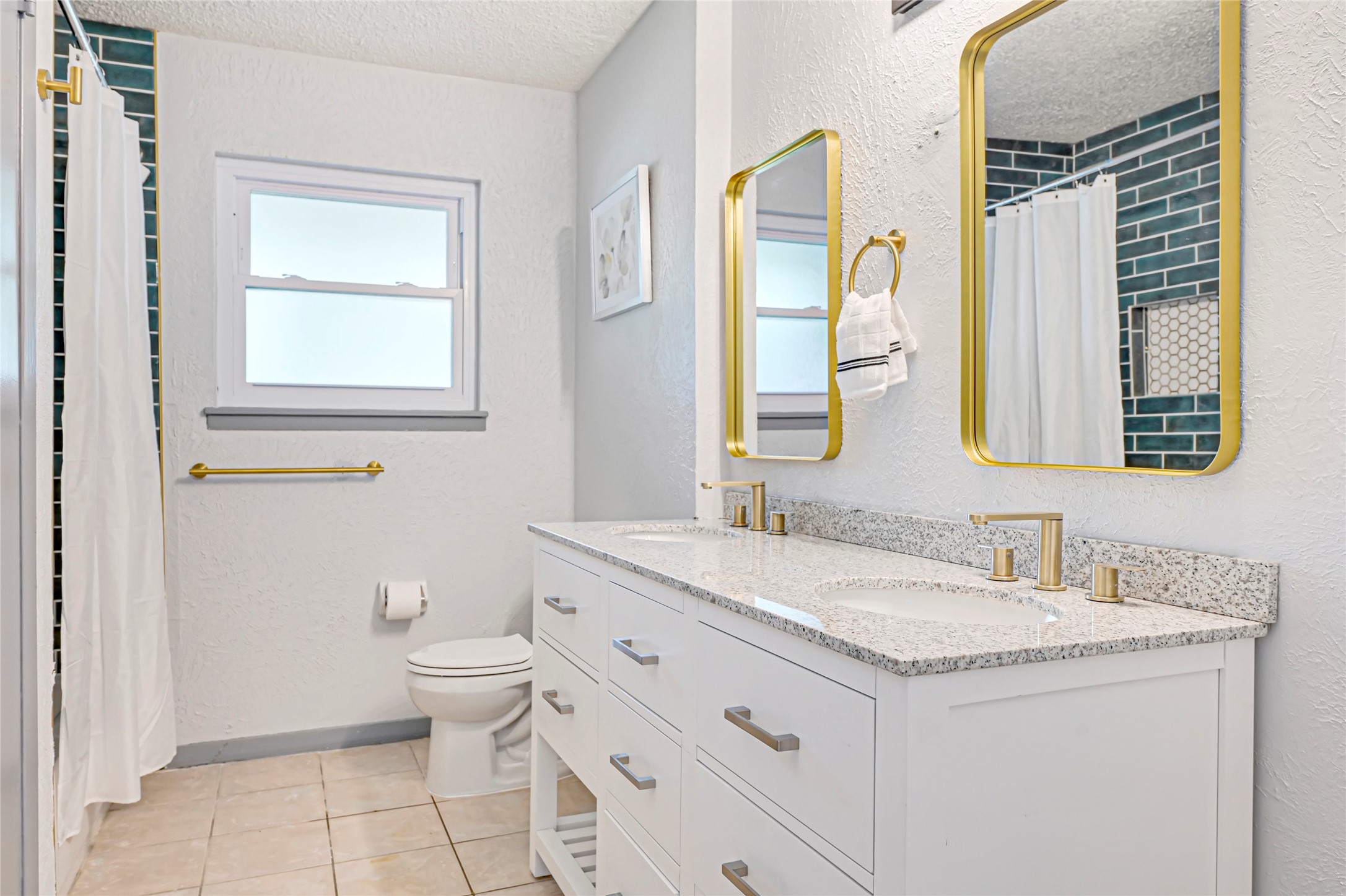 1806 Clayton Drive Baytown, TX 77520 - Photo 14 of 40 a bathroom with a granite countertop toilet a sink and a mirror