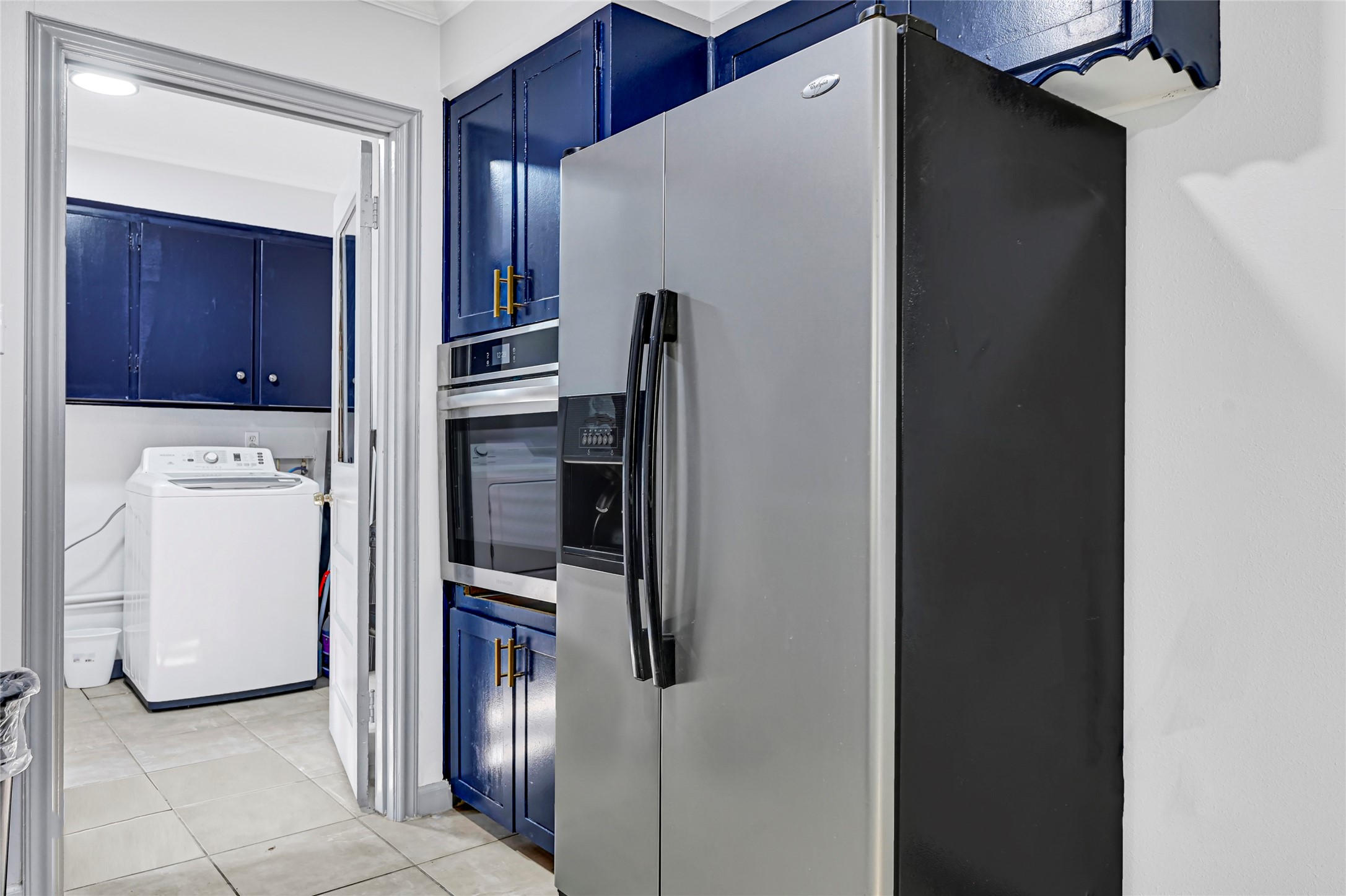 1806 Clayton Drive Baytown, TX 77520 - Photo 21 of 40 a kitchen with a refrigerator and cabinets