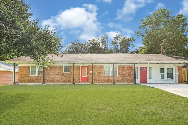 a big house with a big yard and large trees