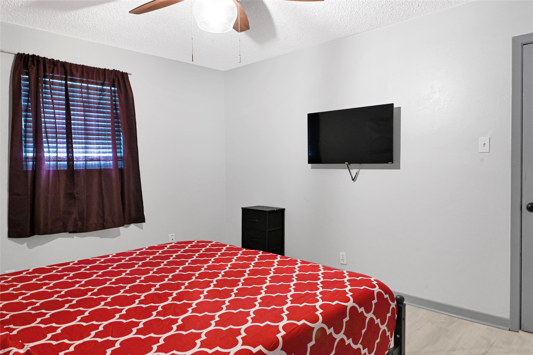 1806 Clayton Drive Baytown, TX 77520 - Photo 38 of 40 a bedroom with a bed and a flat screen tv