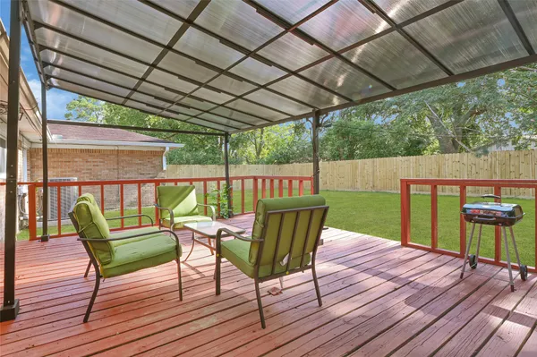 a view of a chair and table on the wooden deck