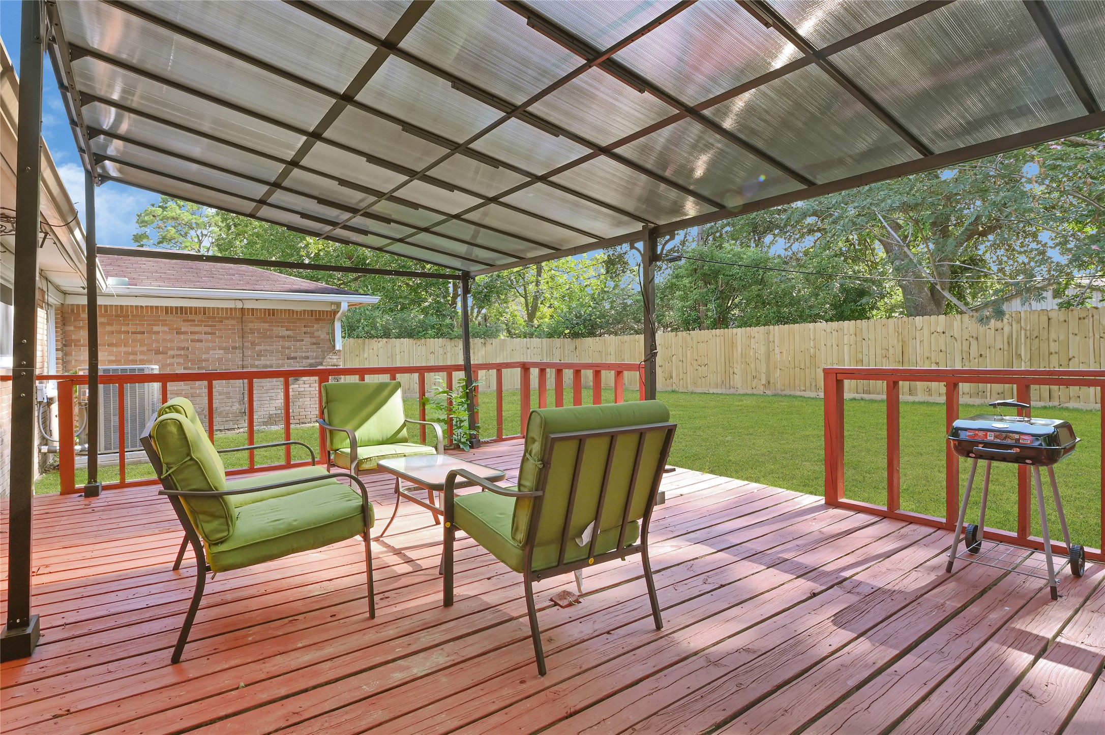 1806 Clayton Drive Baytown, TX 77520 - Photo 4 of 40 a view of a chair and table on the wooden deck