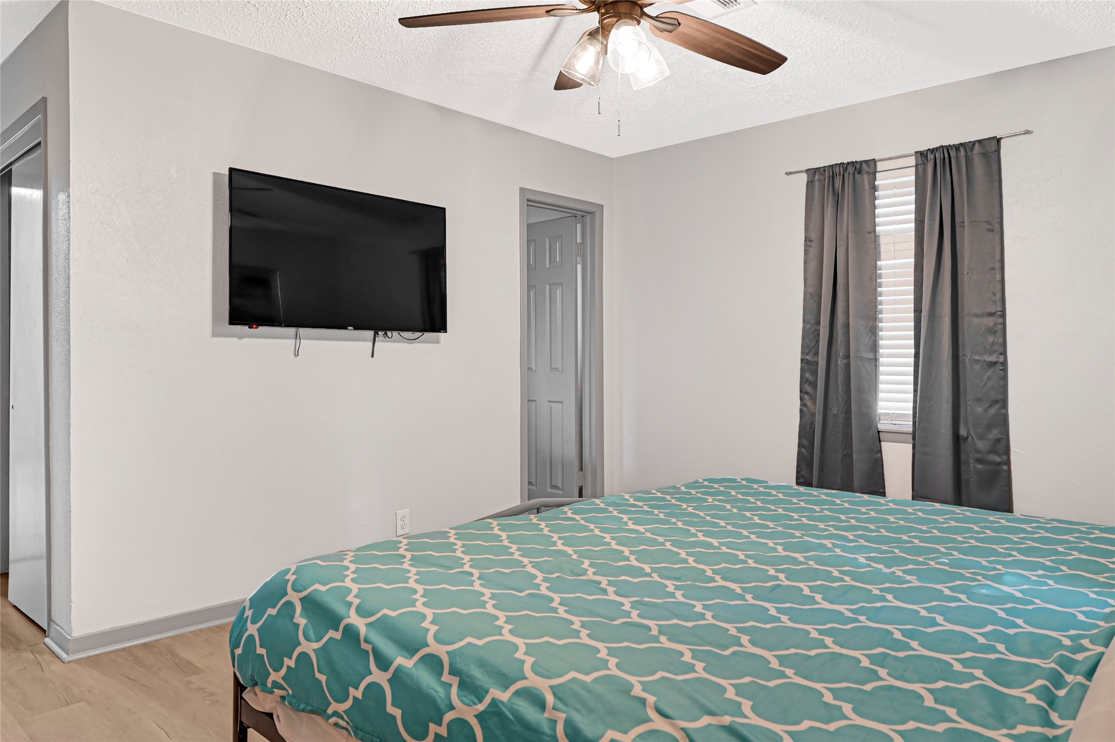 1806 Clayton Drive Baytown, TX 77520 - Photo 6 of 40 a bedroom with a large bed and a flat screen tv