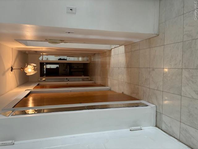 450 Shore Road, Unit 4H Long Beach, NY 11561 - Photo 12 of 17 a view of hallway with a mirror and a shower