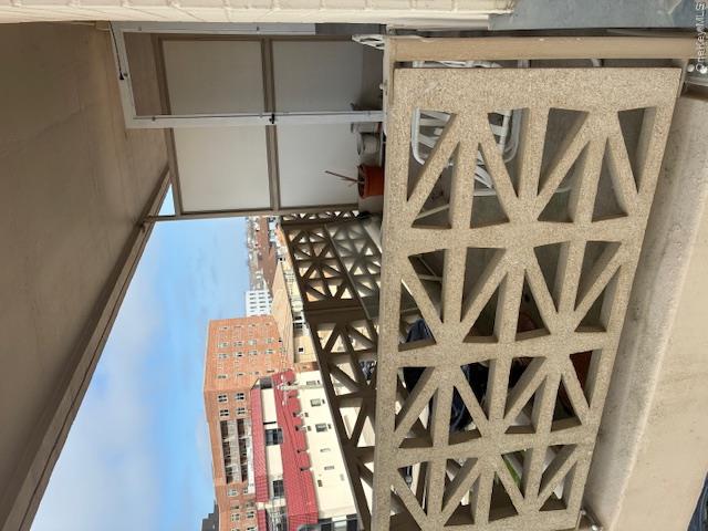450 Shore Road, Unit 4H Long Beach, NY 11561 - Photo 16 of 17 a view of a balcony with wooden floor and windows