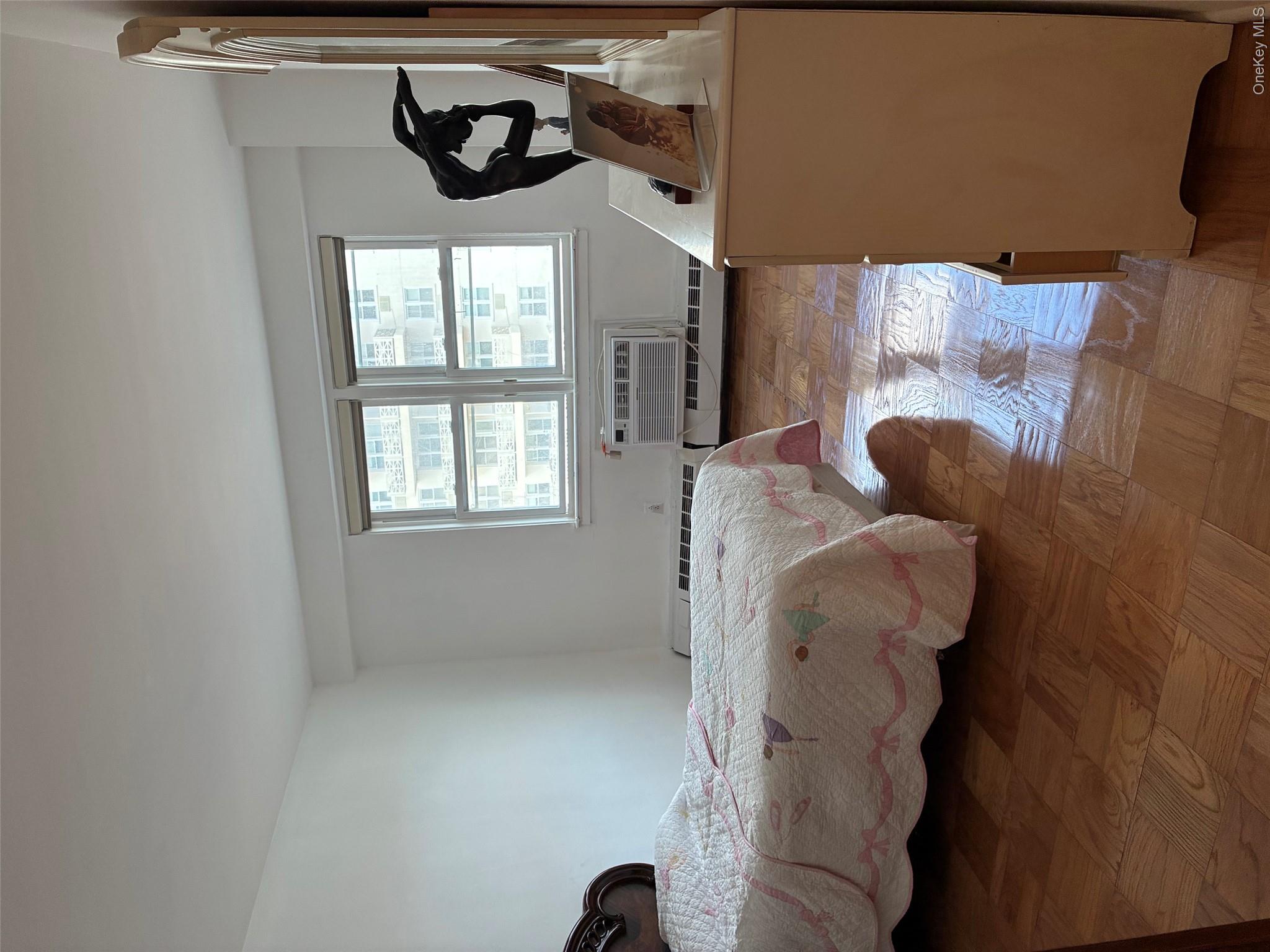 450 Shore Road, Unit 4H Long Beach, NY 11561 - Photo 9 of 17 a bedroom with a bed and window