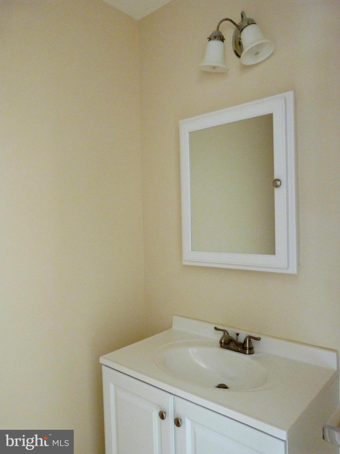 2800 Ridge Road Huntingtown, MD 20639 - Photo 11 of 17 a bathroom with a sink and a mirror