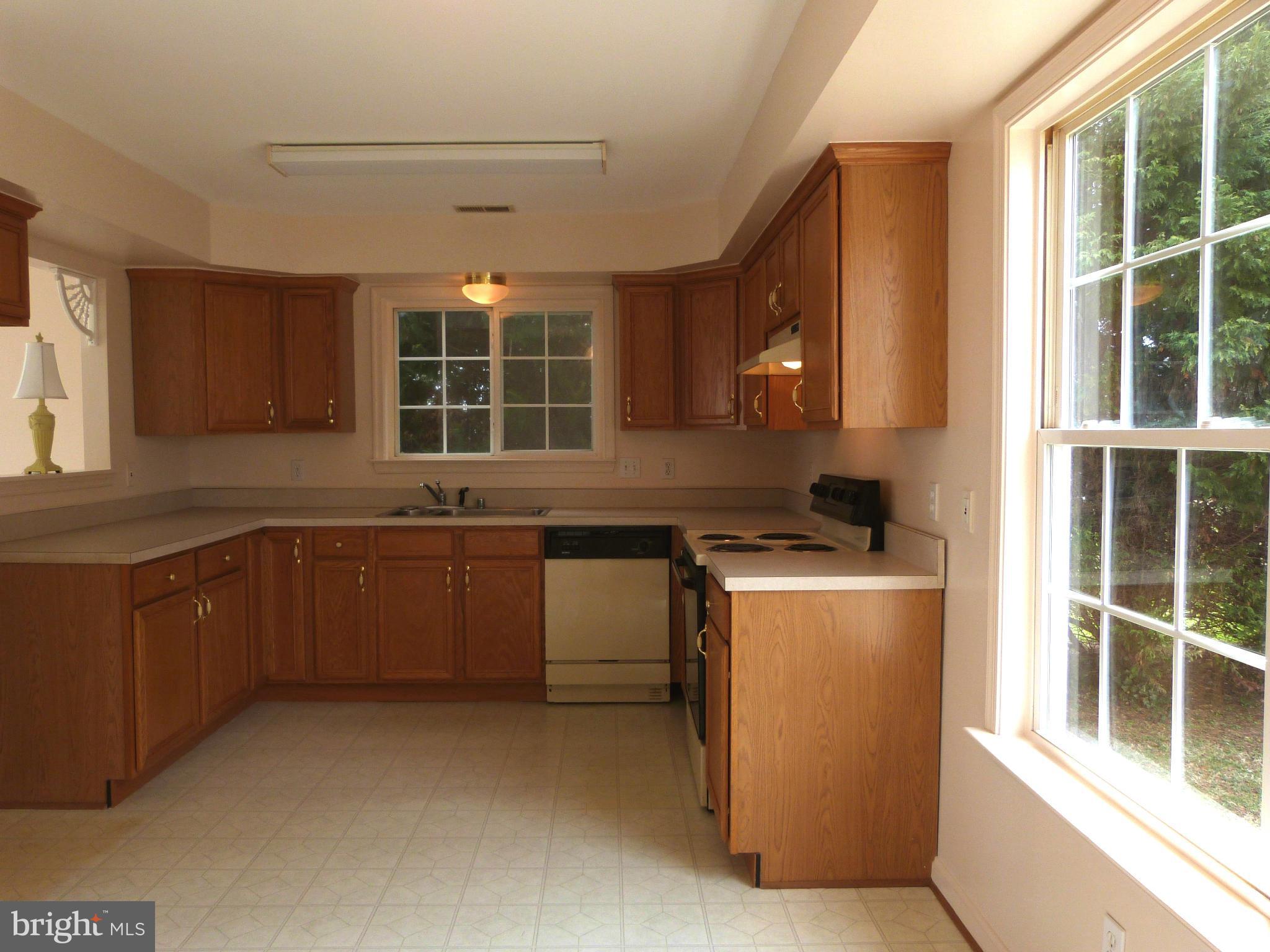 2800 Ridge Road Huntingtown, MD 20639 - Photo 3 of 17 a kitchen with a sink stove and cabinets
