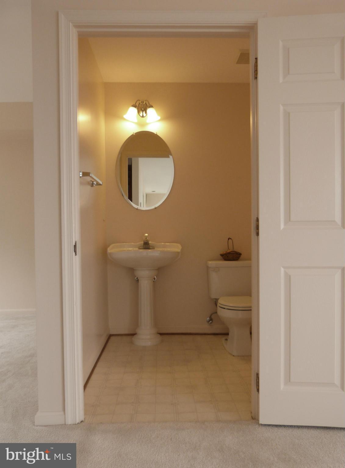 2800 Ridge Road Huntingtown, MD 20639 - Photo 6 of 17 a bathroom with a toilet sink and mirror
