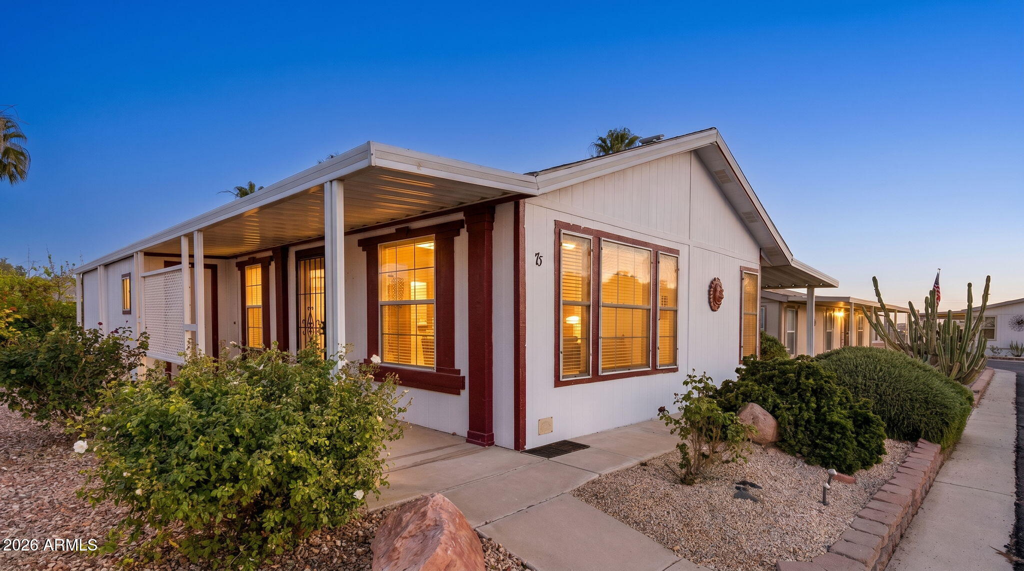 3700 South Tomahawk Road, Unit 73 Apache Junction, AZ 85119 - Photo 1 of 49 a front view of a house with garden