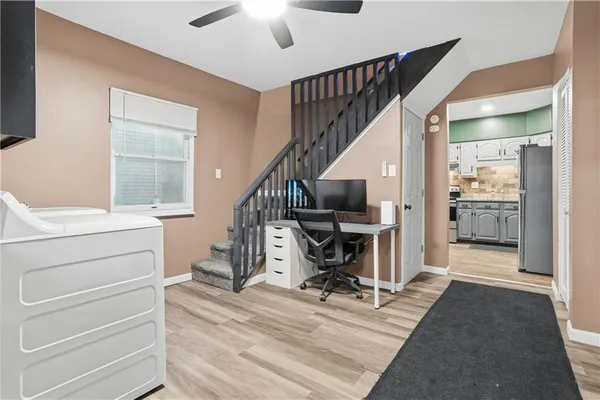 a view of entryway with workspace and wooden floor