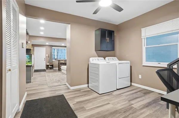 a view of a hallway with workspace and a window