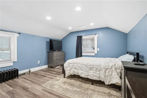 a bedroom with a bed and a tv