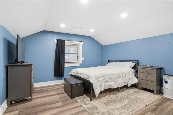 a bedroom with a bed and a television