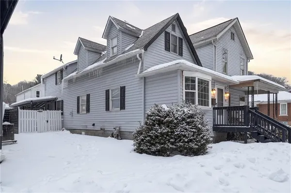 a view of a house with a snow in the yard