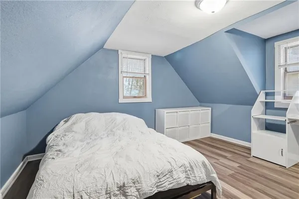 a bedroom with a bed and lamp