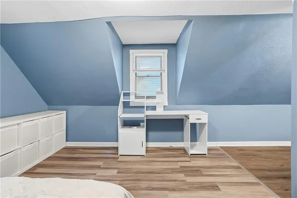 a bathroom with a toilet sink vanity and mirror