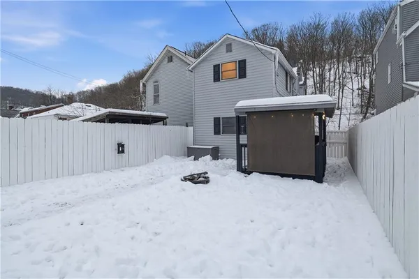 a view of a house with a patio and a yard