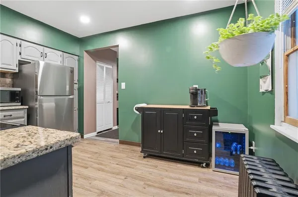 a kitchen with a refrigerator and a sink