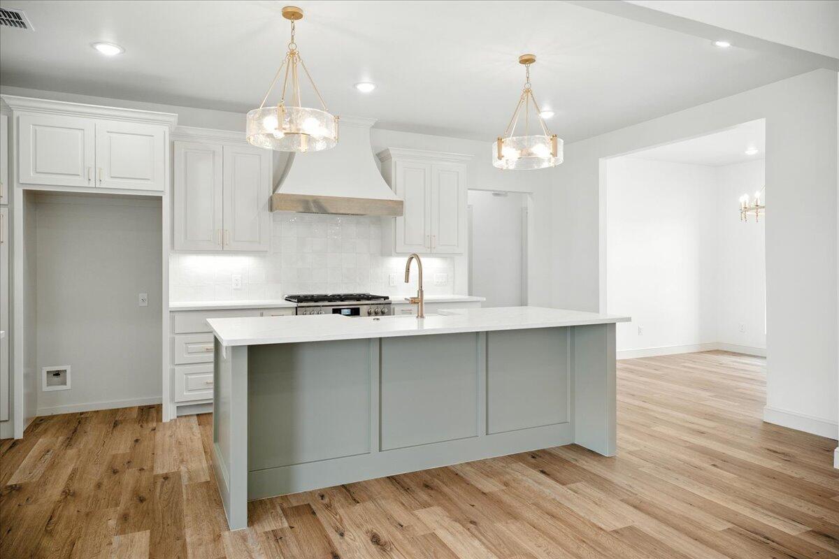 3615 143rd Street Lubbock, TX 79423 - Photo 13 of 32 a view of a kitchen with a sink and wooden floor