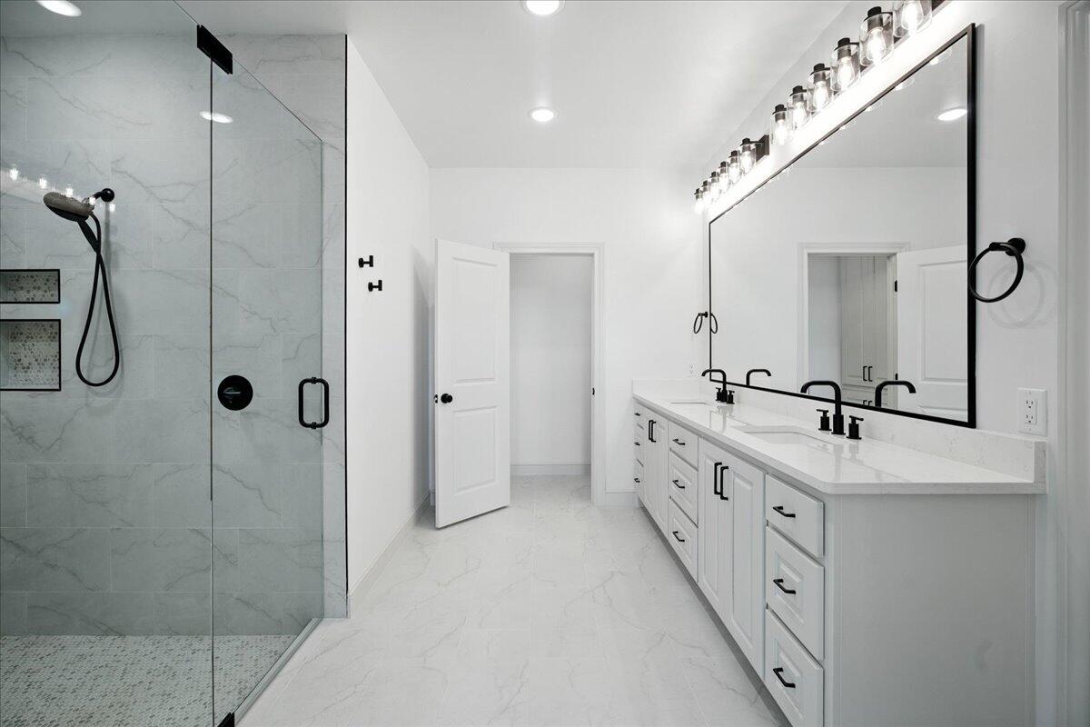 3615 143rd Street Lubbock, TX 79423 - Photo 16 of 32 a bathroom with a double vanity sink mirror double and shower