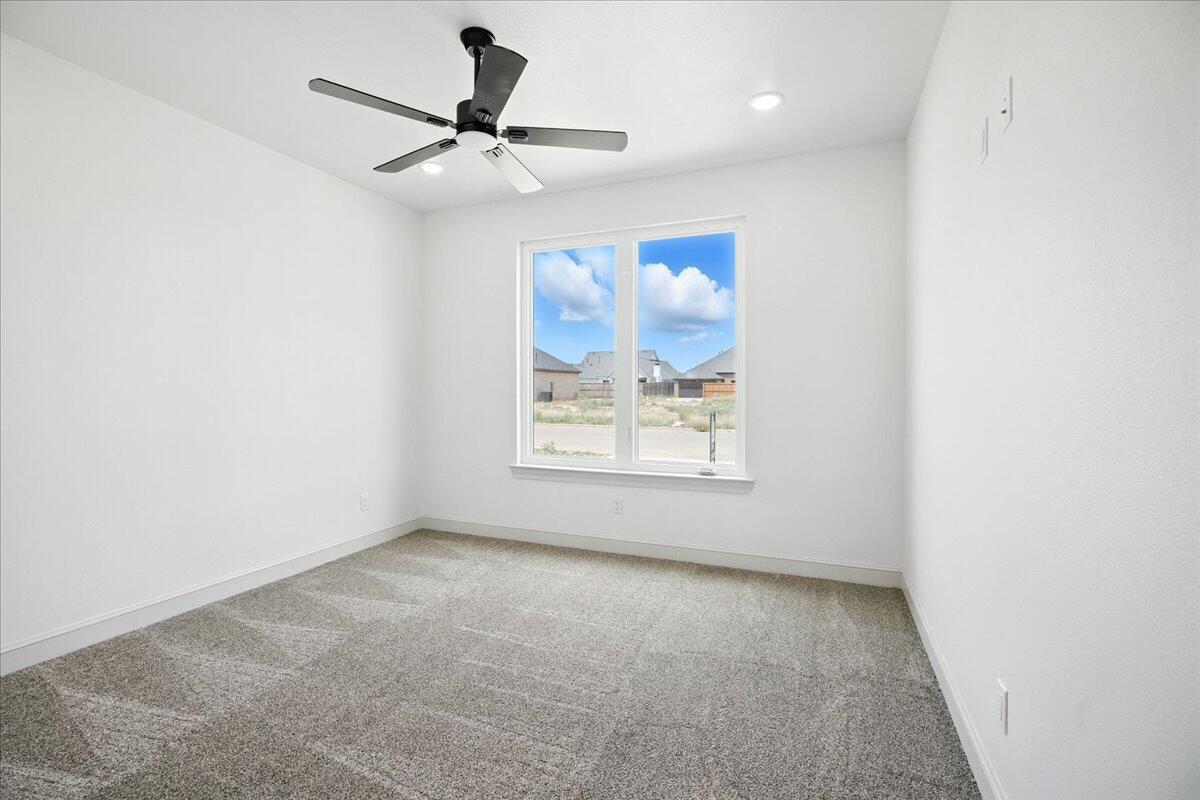 3615 143rd Street Lubbock, TX 79423 - Photo 24 of 32 an empty room with a window and a ceiling fan