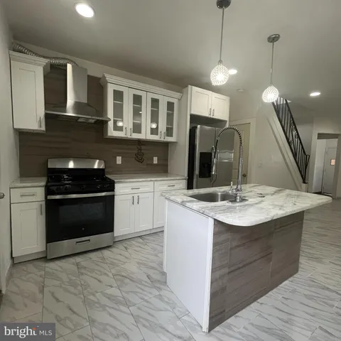 a kitchen with a sink and stove