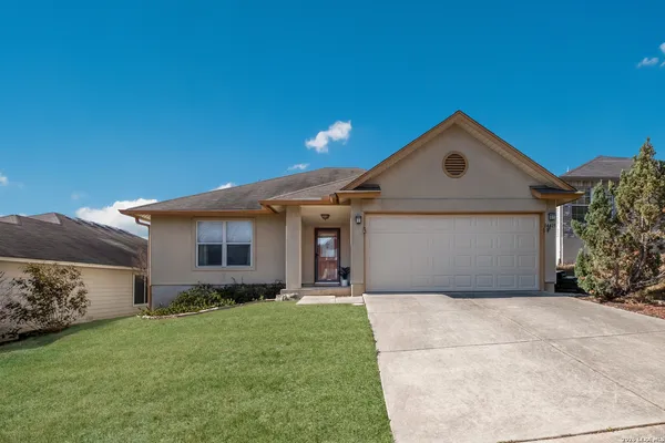 a front view of house with yard and green space