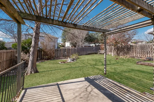 a view of backyard with wooden fence