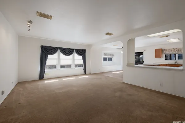 a view of a big room with closet and windows