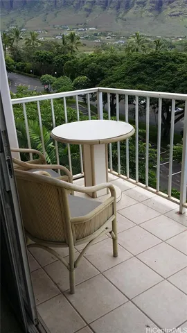 a view of a chairs and table in the backyard
