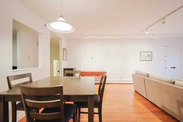 a view of a dining room with furniture and wooden floor