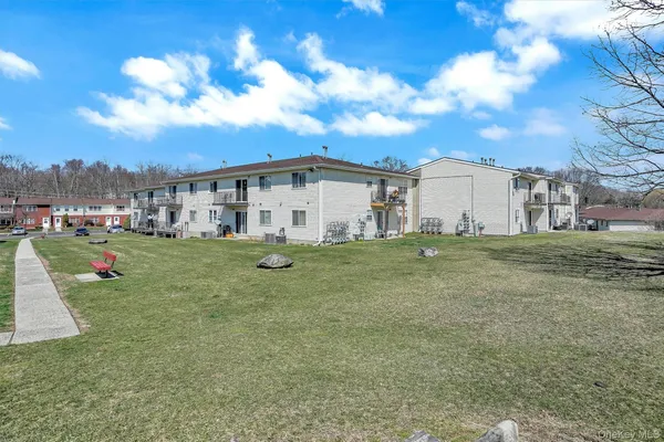 a view of a white house with a big yard