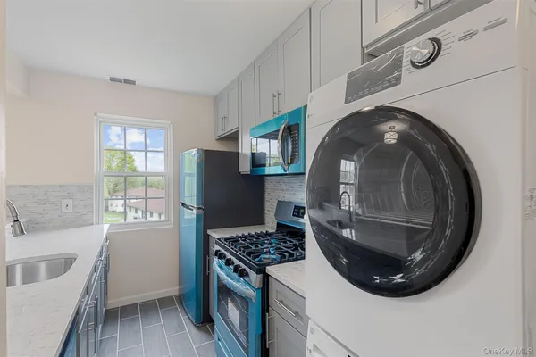 a kitchen with a stove and a wooden floor