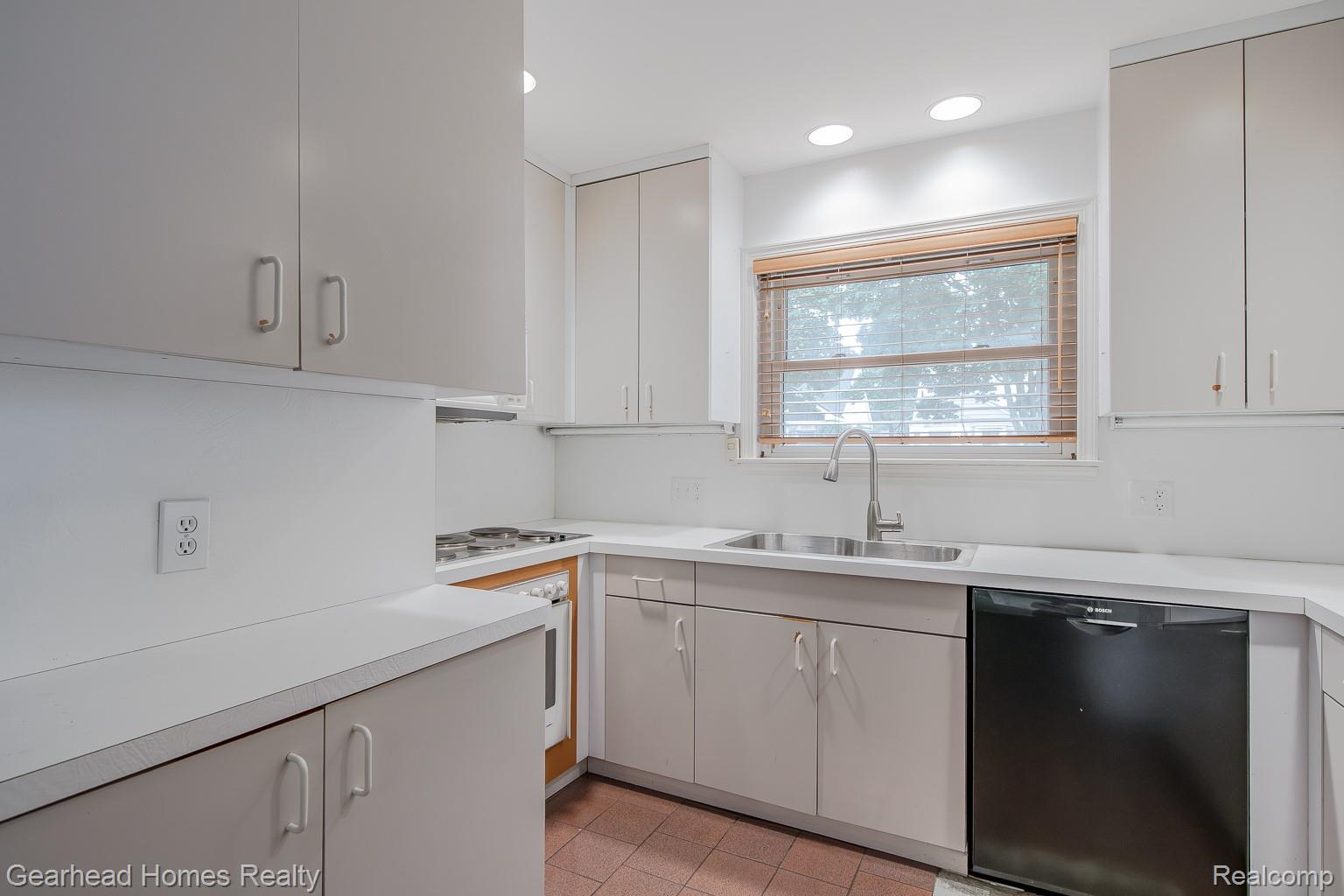 3356 Harding Street Dearborn, MI 48124 - Photo 12 of 48 Light-toned cabinetry with coordinating hardware, sleek countertops, and a stainless steel sink with a gooseneck faucet