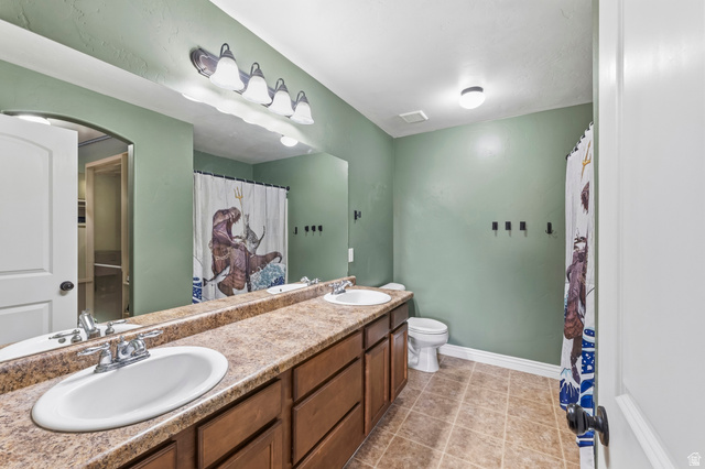 1165 West 100 South Springville, UT 84663 - Photo 12 of 28 Full bathroom with double vanity, curtained shower, and light tile patterned flooring