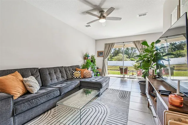 a living room with furniture and a potted plant