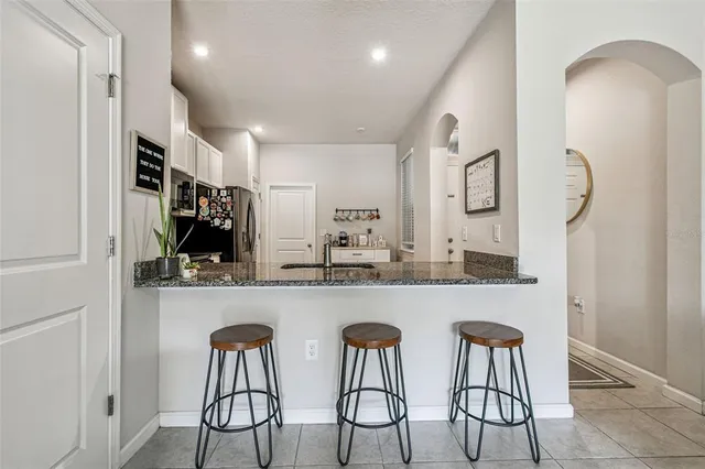 a living room filled with furniture and a potted plant