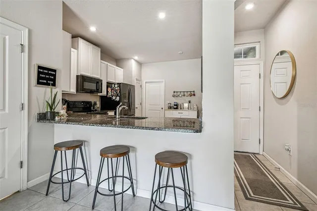 a view of a living room with a fireplace and floor to ceiling windows