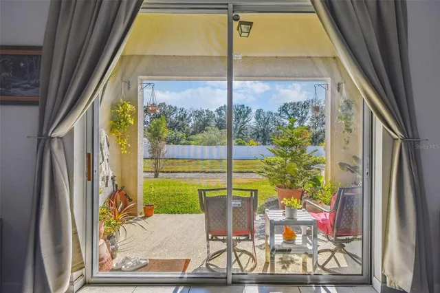 a view of a swimming pool with an outdoor seating and a yard