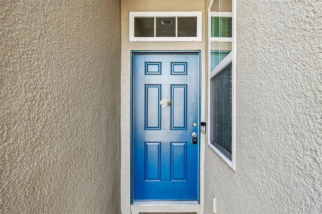 a view of a hallway with wooden floor and a living room
