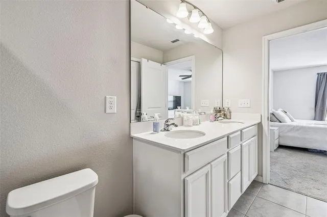 a bedroom with a bed and a ceiling fan