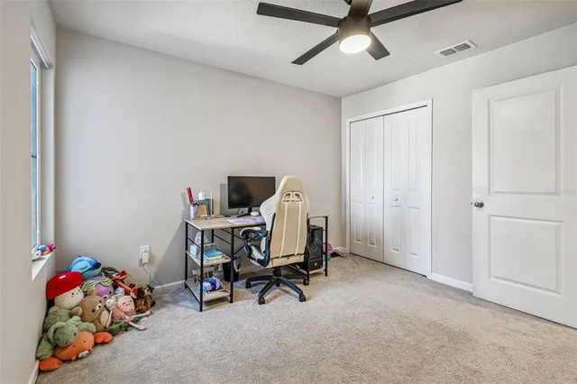 a view of a white house with swimming pool and a small yard