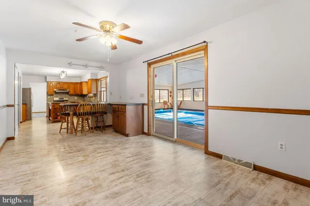 an empty room with furniture and a chandelier