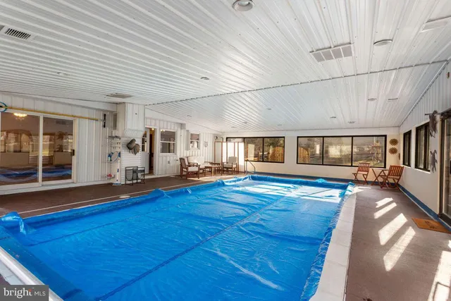 a view of swimming pool with seating space