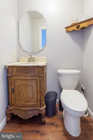 a bathroom with a toilet and a mirror