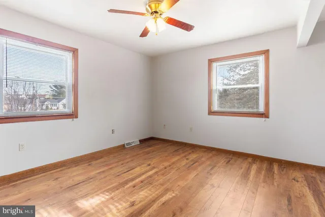 a view of an empty room with wooden floor