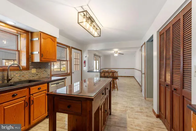 a kitchen with granite countertop a sink and a refrigerator