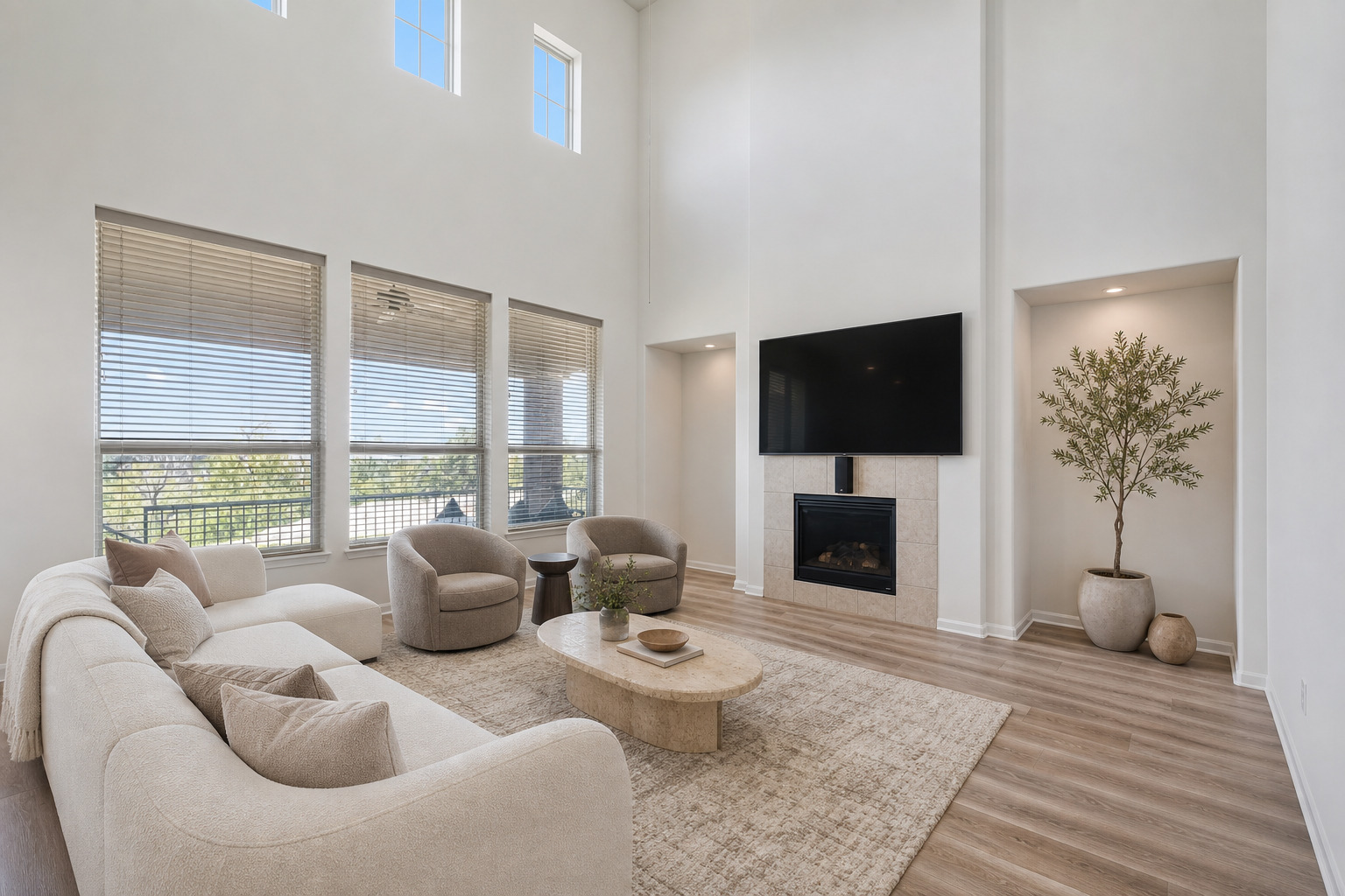 Towering ceilings and a minimalist fireplace anchor this light-filled main living space.