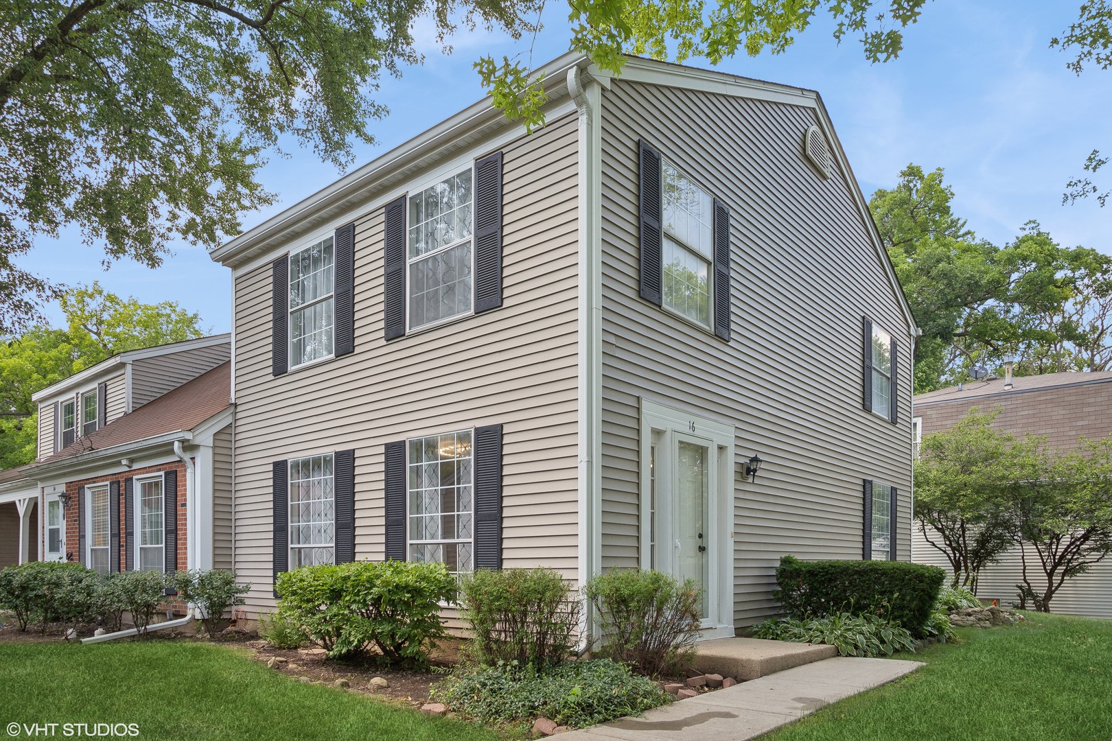 a front view of a house with garden